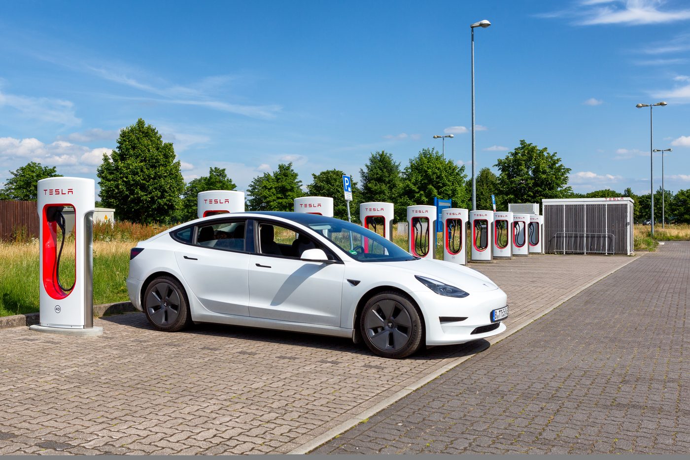 A row of Tesla Superchargers at a German service area in winter light