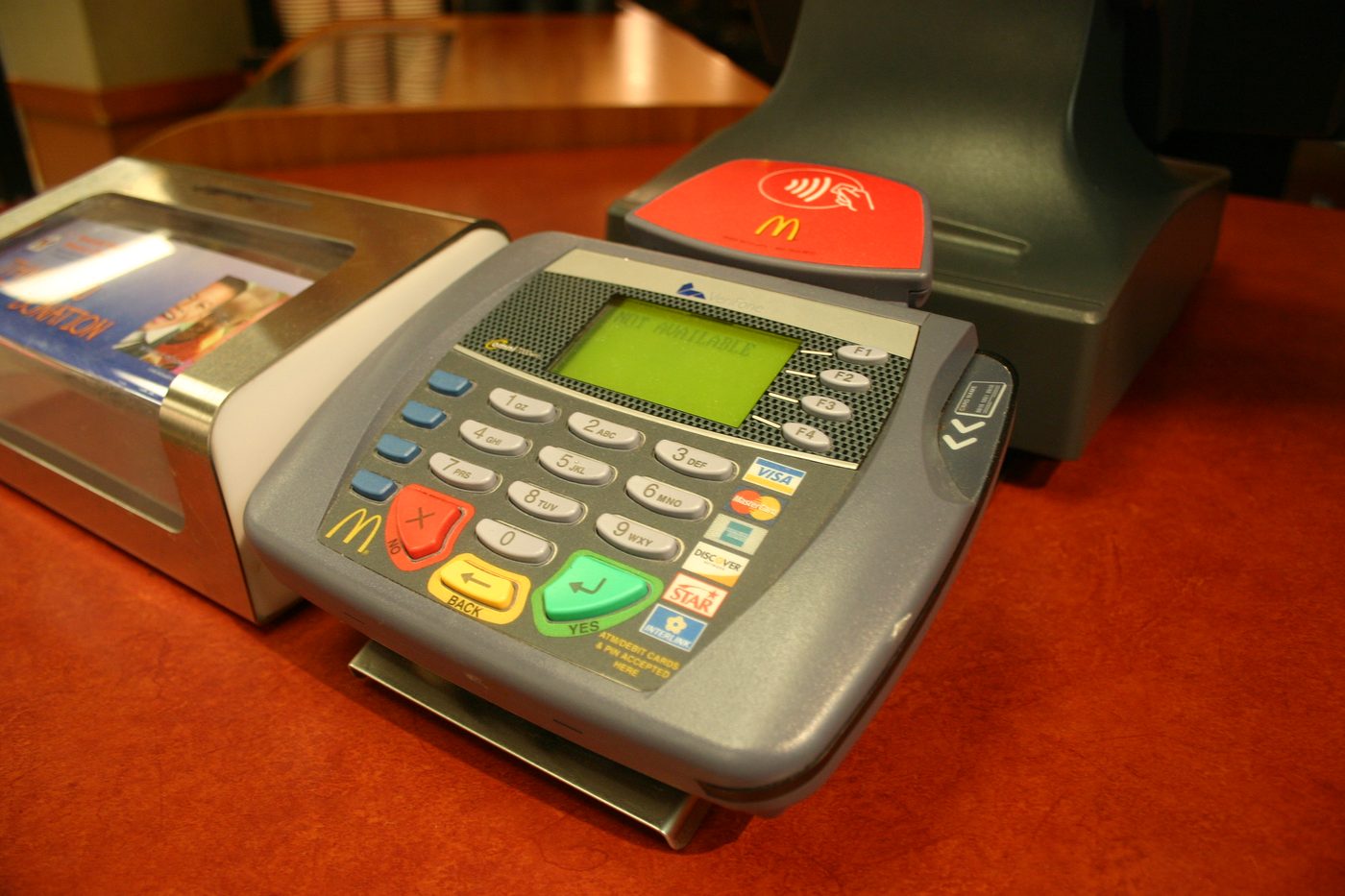A contactless card terminal at a fast-food counter