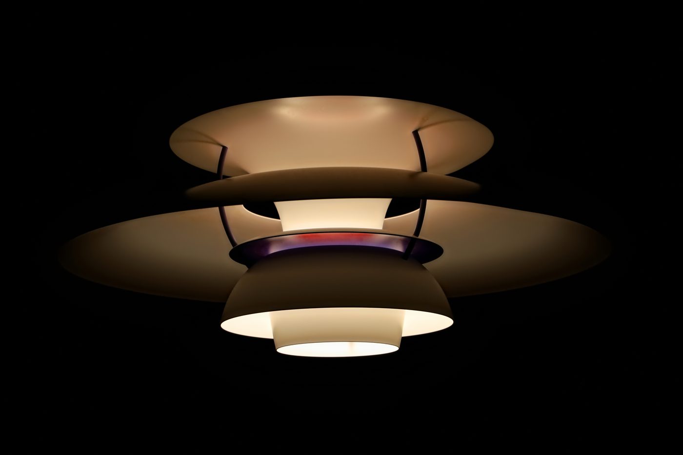 A Louis Poulsen PH5 pendant lamp by Poul Henningsen, hanging in a domestic interior