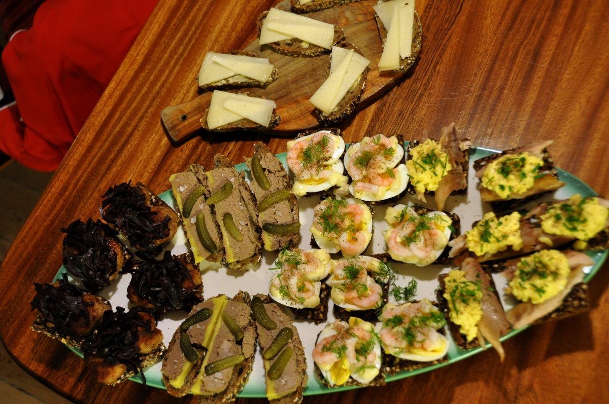 A spread of Danish smørrebrød with herring, prawn and roast beef toppings