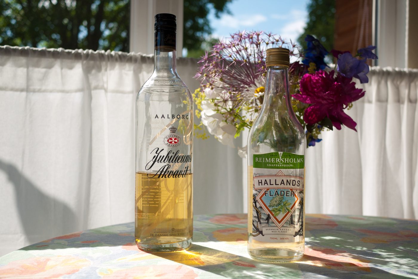 Bottles of Danish akvavit / aquavit lined up — the snaps tradition