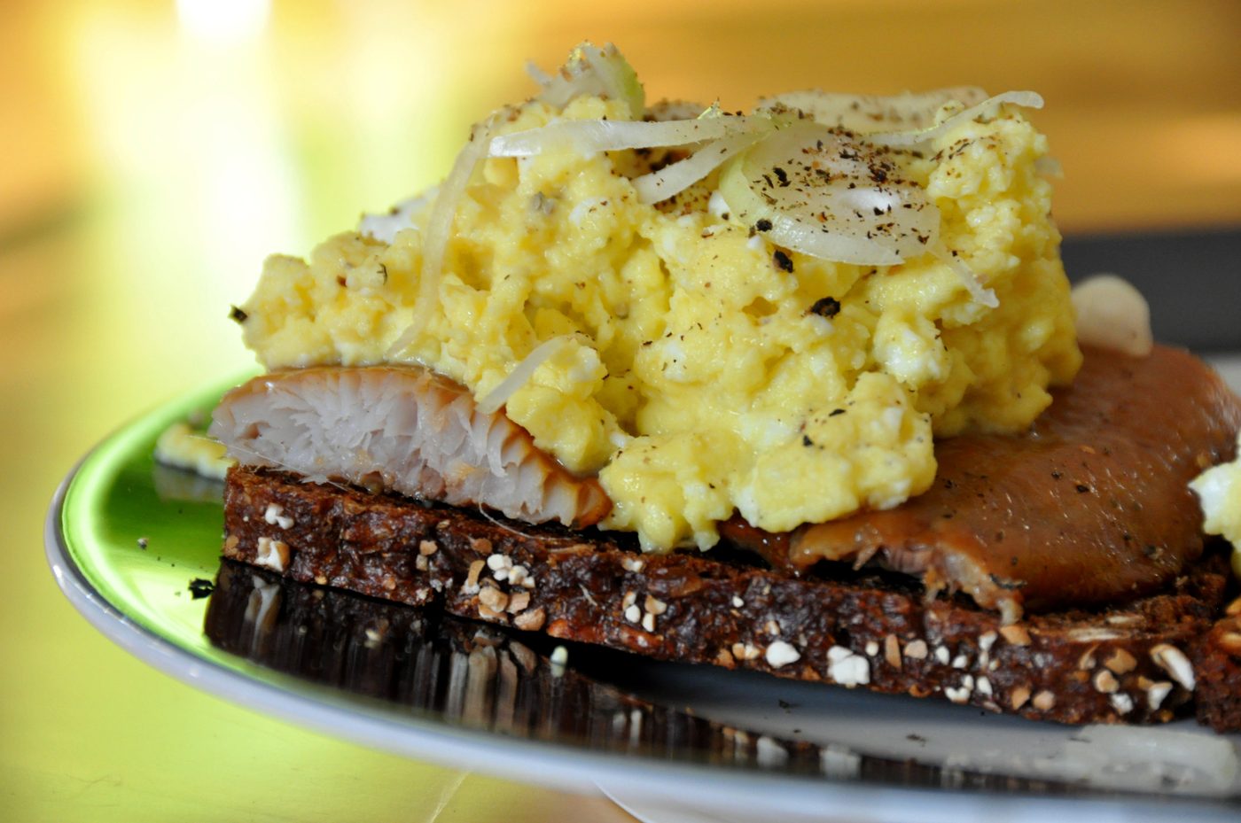 Smoked herring on toasted rye bread with shallots and salmon roe