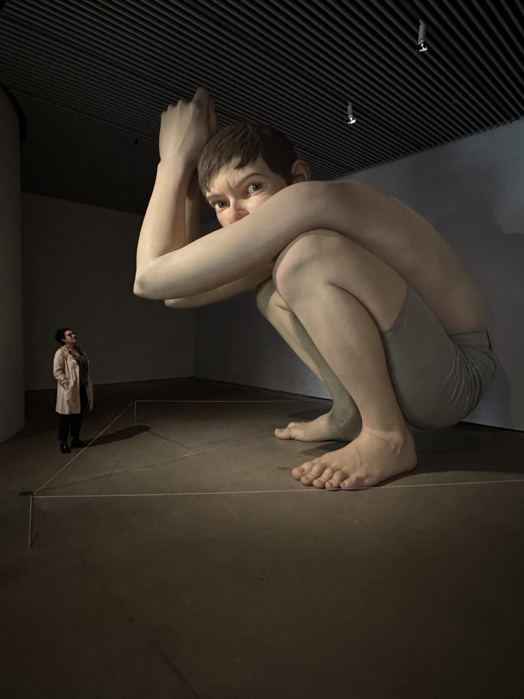 Ron Mueck Boy sculpture at ARoS Aarhus — a 4.5-metre crouching figure