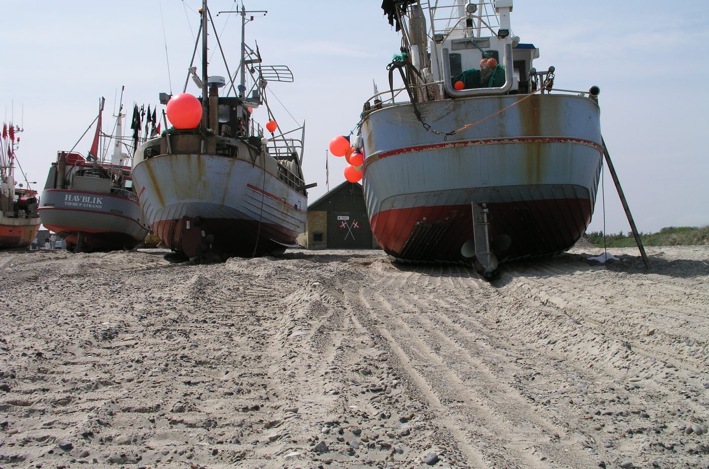 Wooden fishing cutters hauled up on the sand at Thorup Strand, Danish west coast